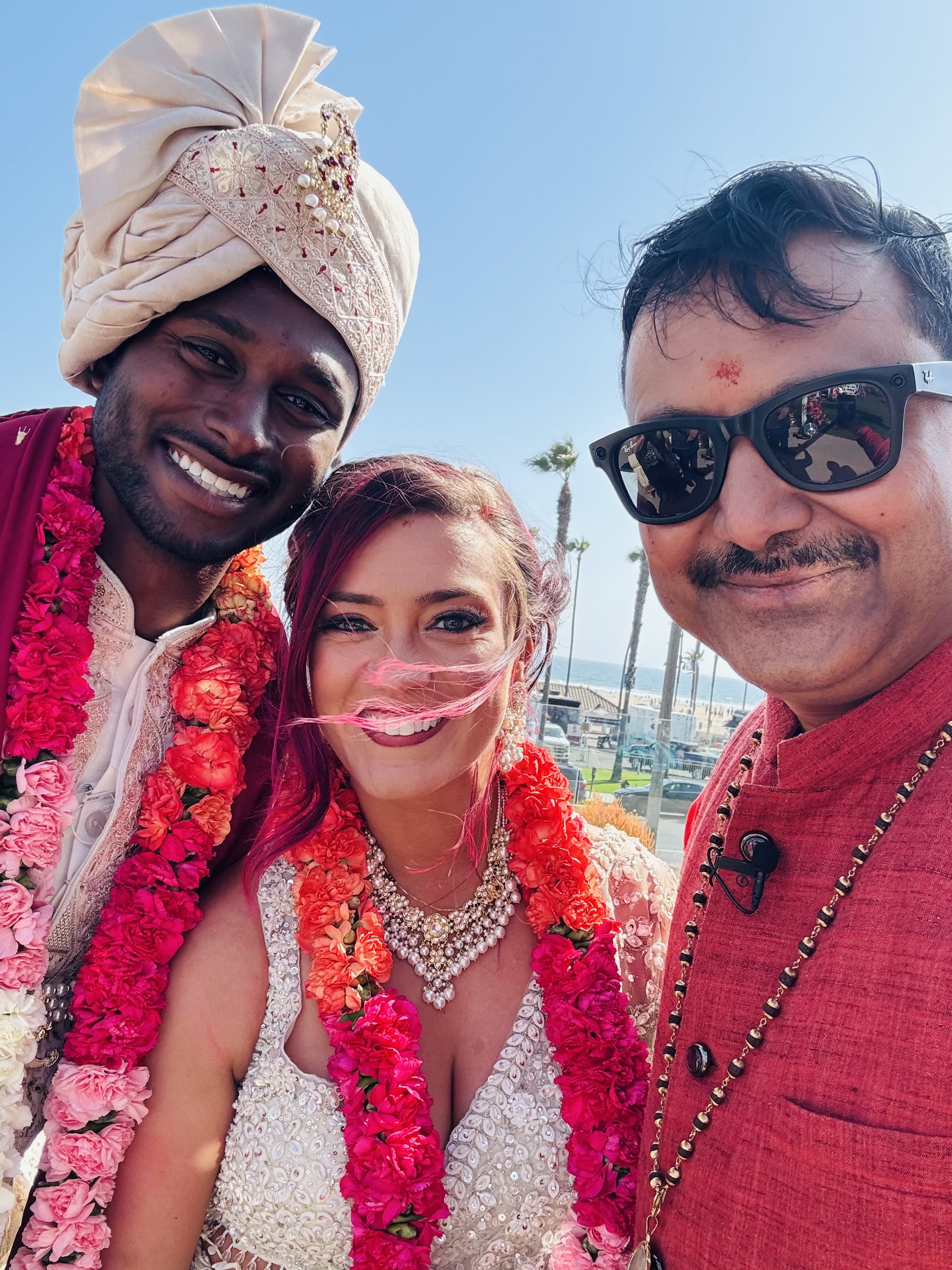 Premier Hindu wedding officiant Pandit Manuj Dutt with intercultural couple at a California beachside ceremony